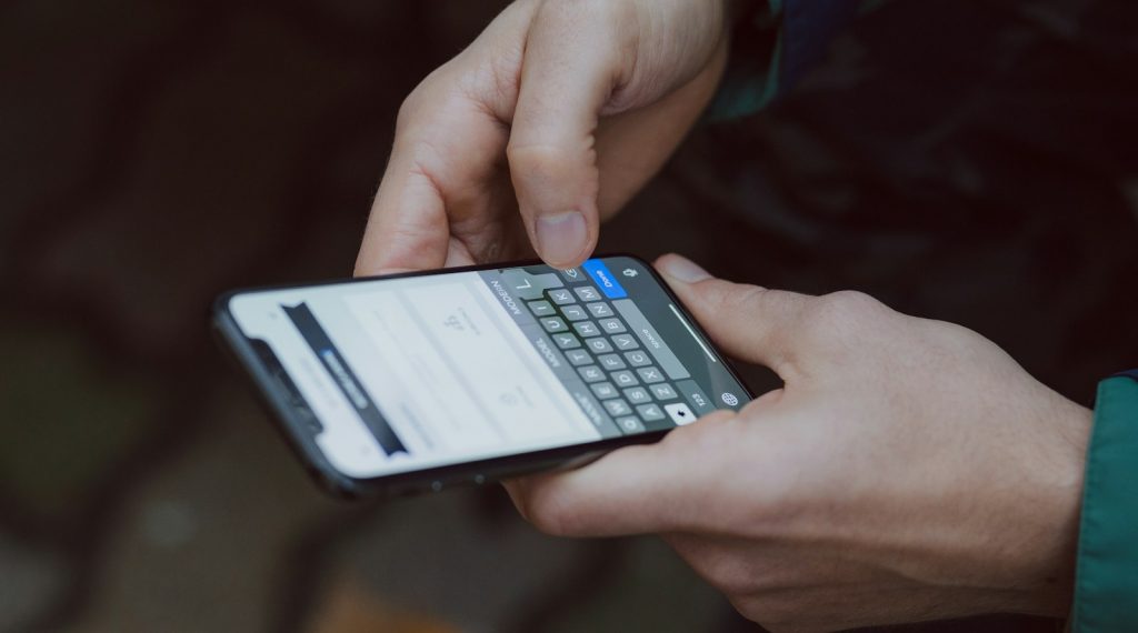 selective focus photography of person using smartphone